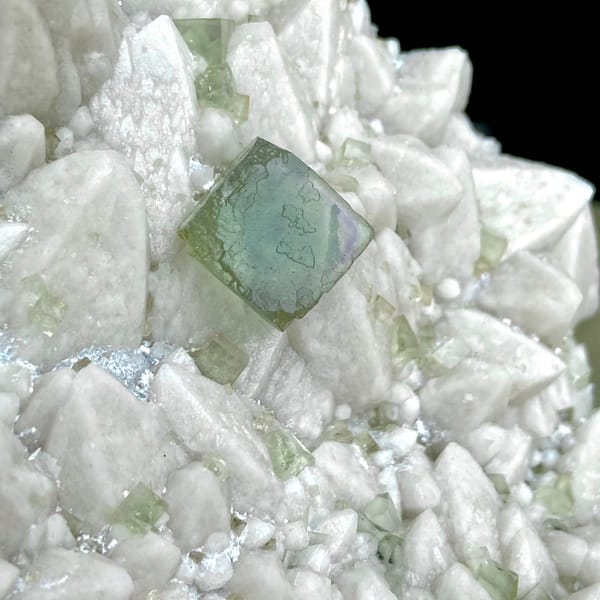 White quartz plate with pale green fluorite cubes from Inner Mongolia, China, side view