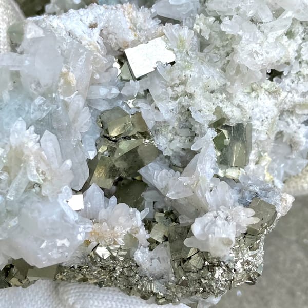 White quartz cluster studded with pyrite cubes from Shangbao, Hunan, China, detail of the matrix contact