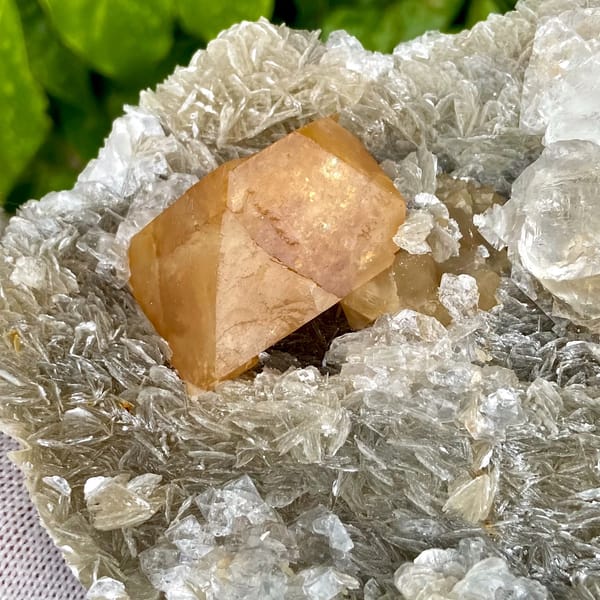 Orange scheelite and frosted fluorite on silvery mica from Xuebaoding, Sichuan, China, second angle