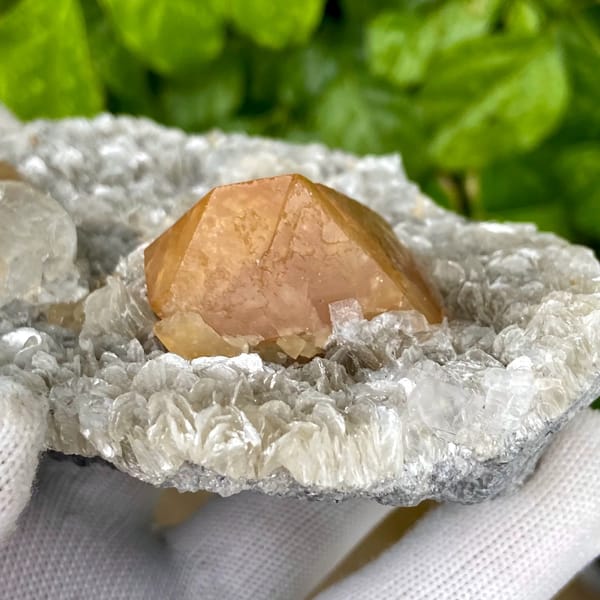 Orange scheelite and frosted fluorite on silvery mica from Xuebaoding, Sichuan, China, side view
