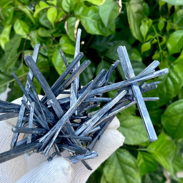 Floater spray of steel-grey stibnite needles from Jiangxi, China, detail of the matrix contact