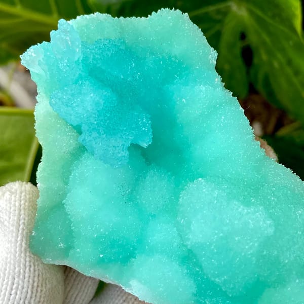 Mound of mint-green acicular aragonite from Sichuan, China, detail of the matrix contact