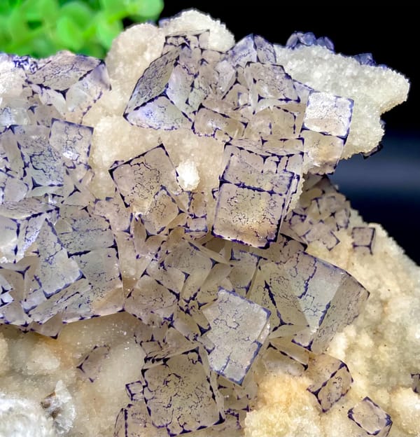 Pale fluorite cubes outlined in purple on white quartz from Guizhou, China, side view