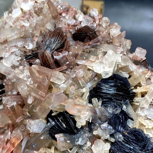 Plate of black specular hematite with pink-skinned quartz from Guangdong, China, reverse side