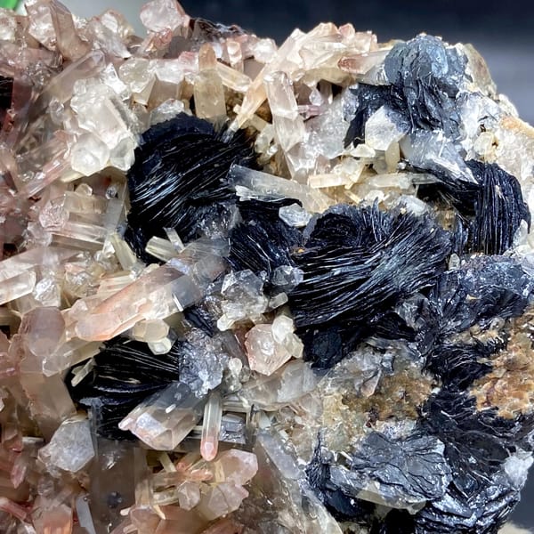 Plate of black specular hematite with pink-skinned quartz from Guangdong, China, top view