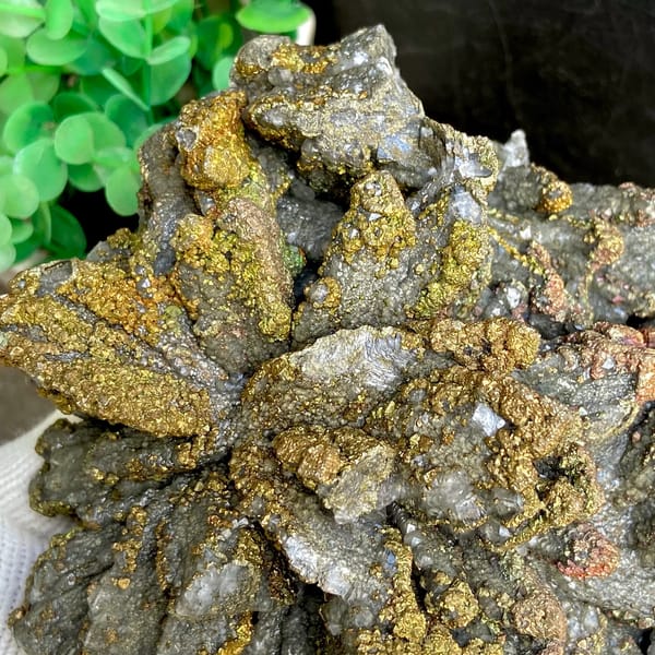 Plate of petal calcite coated in iridescent pyrite from Hubei, China, detail of the matrix contact