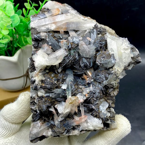 Plate of black specular hematite with quartz prisms from Guangdong, China, close-up of the crystal faces