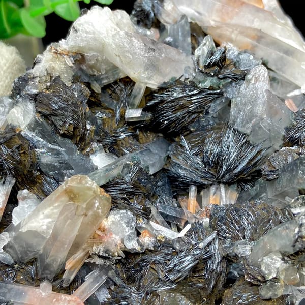 Plate of black specular hematite with quartz prisms from Guangdong, China, top view