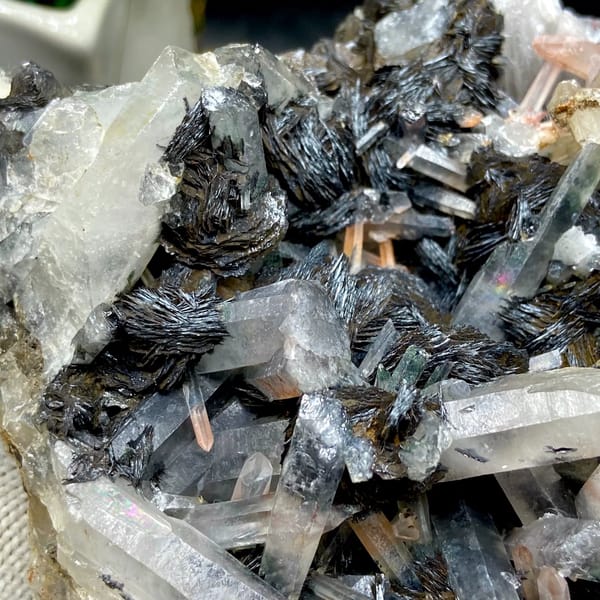 Plate of black specular hematite with quartz prisms from Guangdong, China, side view