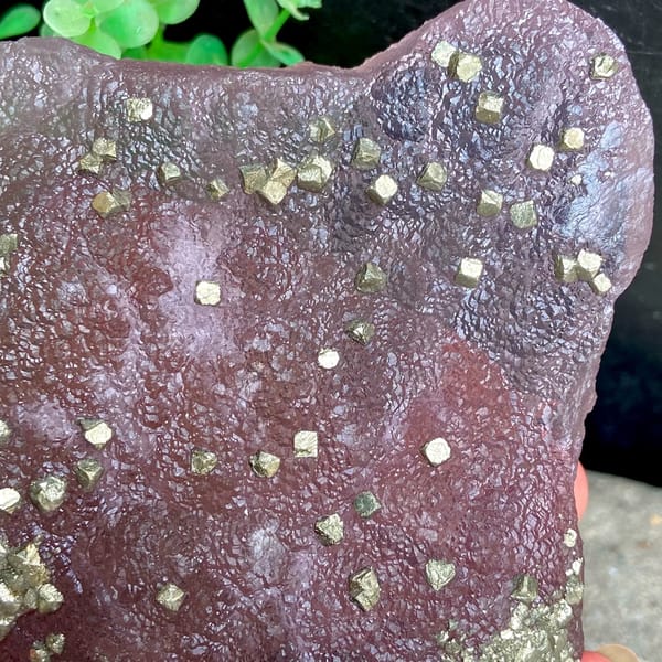 Pink-purple botryoidal fluorite dome speckled with pyrite from Jiangxi, China, top view