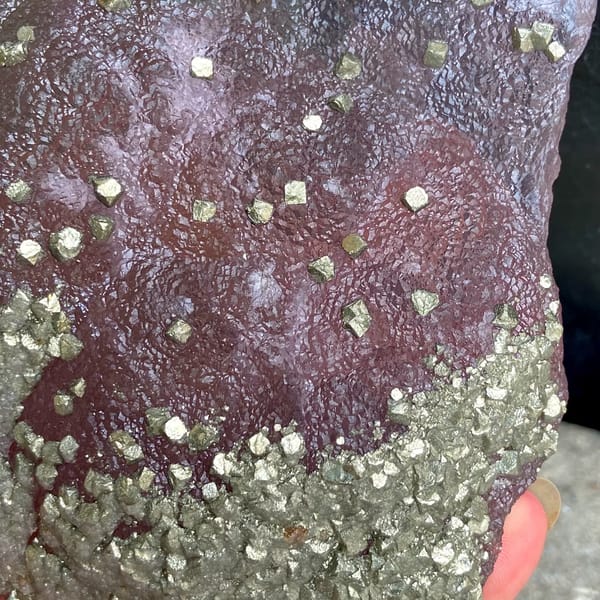 Pink-purple botryoidal fluorite dome speckled with pyrite from Jiangxi, China, close-up of terminations