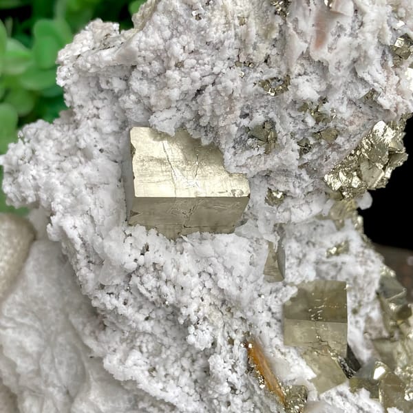 Pyrite cluster set in white matrix from Shangbao, Hunan, China, close-up of the crystal faces
