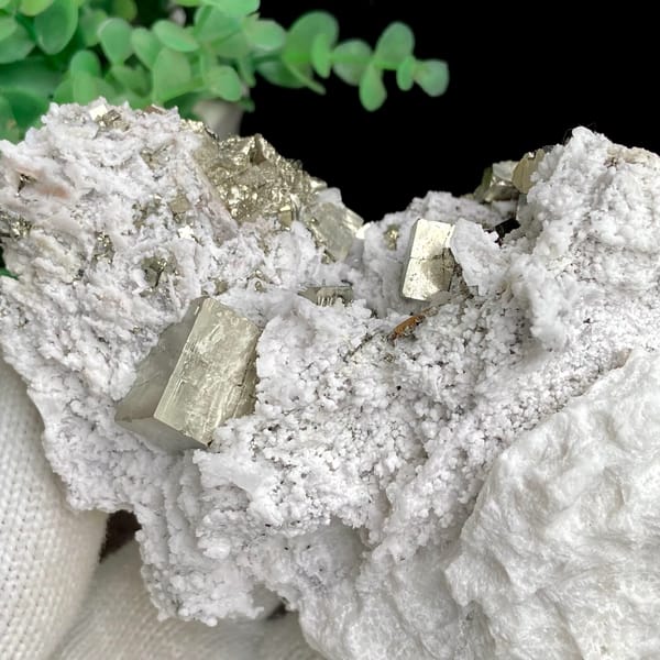 Pyrite cluster set in white matrix from Shangbao, Hunan, China, detail of the matrix contact
