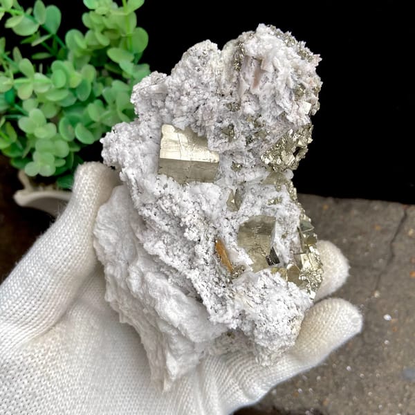 Pyrite cluster set in white matrix from Shangbao, Hunan, China, close-up of terminations