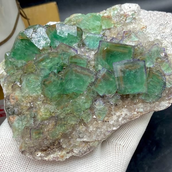 Plate of glassy green fluorite cubes with purple edges from Hebei, China, close-up of terminations