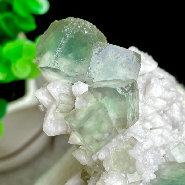 Sea-green fluorite cubes crowning white quartz cluster from Inner Mongolia, China, side view