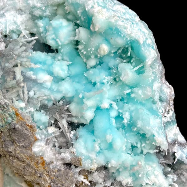 Sky-blue botryoidal aragonite over white needles from Yunnan, China, detail of the matrix contact