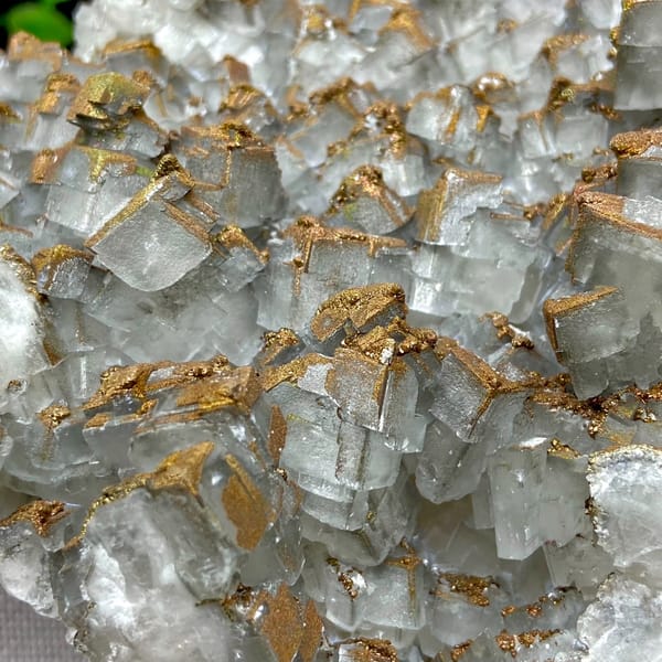 Plate of pale pyramid calcite coated in rusty iridescent pyrite from Hunan, China, top view