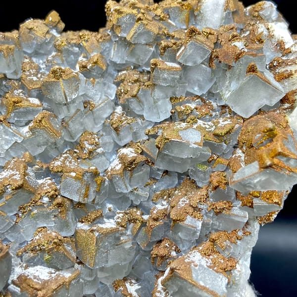 Plate of pale pyramid calcite coated in rusty iridescent pyrite from Hunan, China, side view