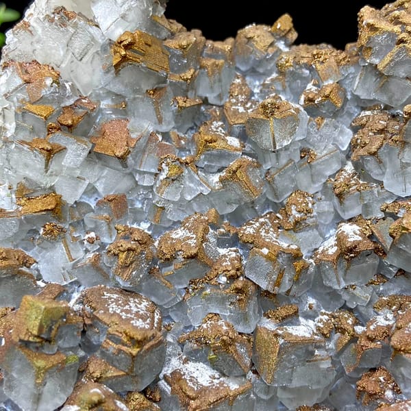 Plate of pale pyramid calcite coated in rusty iridescent pyrite from Hunan, China, close-up of terminations