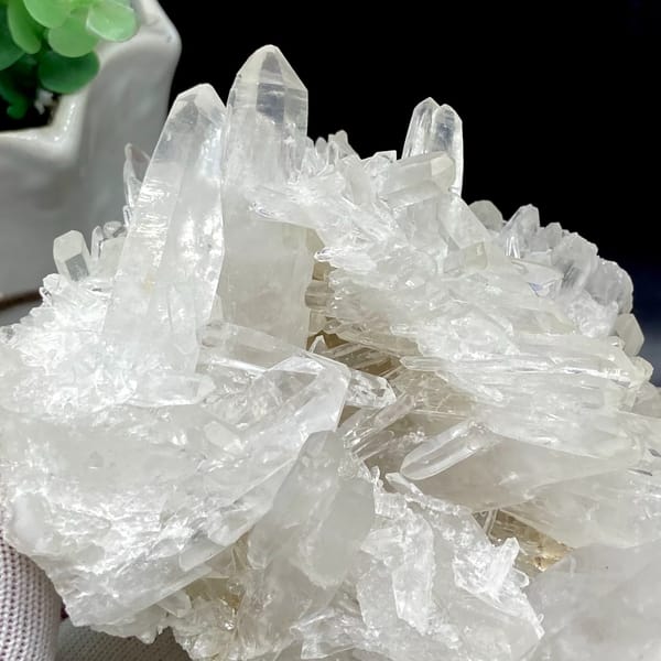 Cluster of clear double-terminated quartz needles from Jinkouhe, Sichuan, China, detail of the matrix contact