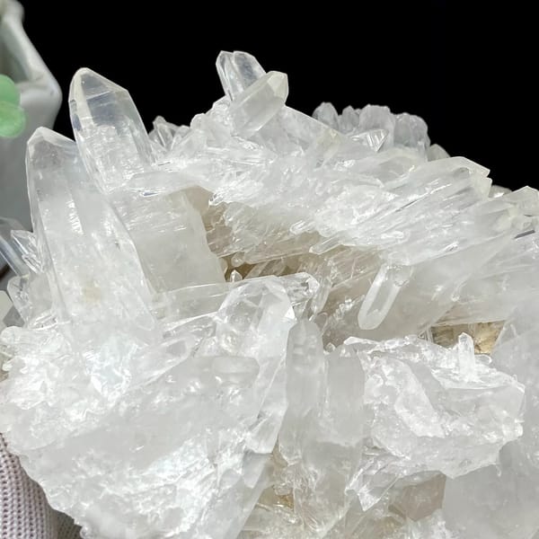 Cluster of clear double-terminated quartz needles from Jinkouhe, Sichuan, China, side view