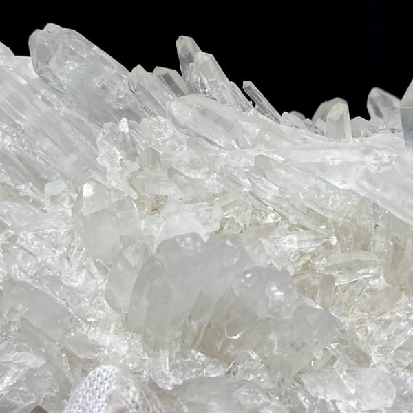 Cluster of clear double-terminated quartz needles from Jinkouhe, Sichuan, China, close-up of terminations