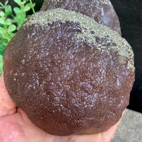 Plum-purple botryoidal fluorite ball dusted with pyrite from Jiangxi, China, top view