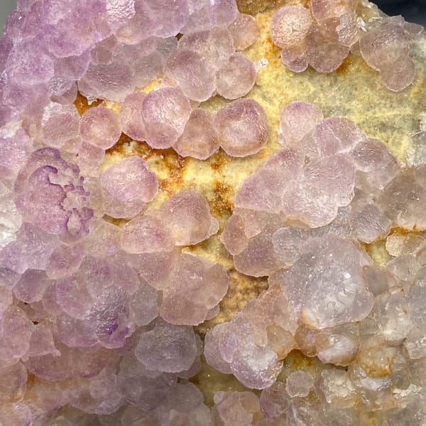 Plate of lavender botryoidal fluorite from Guizhou, China, detail of the matrix contact
