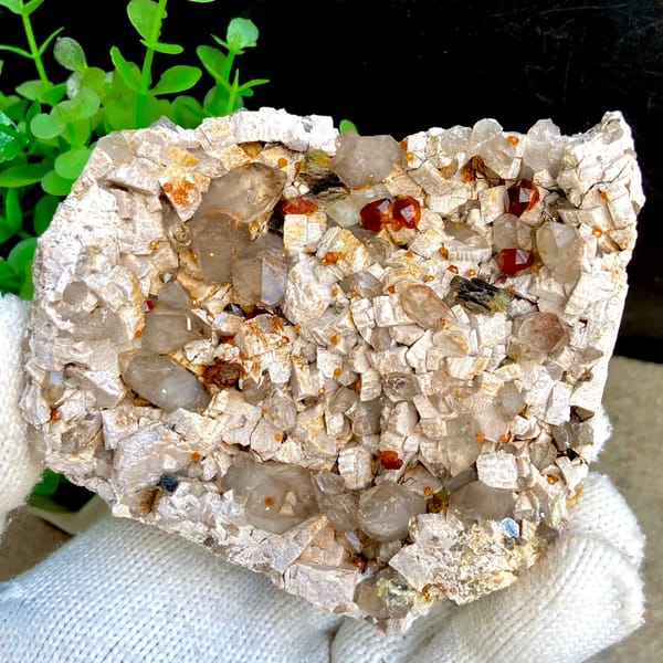 Wine-red garnets scattered over pale quartz plate from Fujian, China, second angle