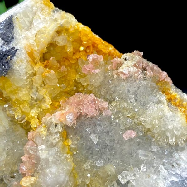 Platy rhodochrosite in quartz pocket rimmed by dark sulfide from Guangxi, China, top view