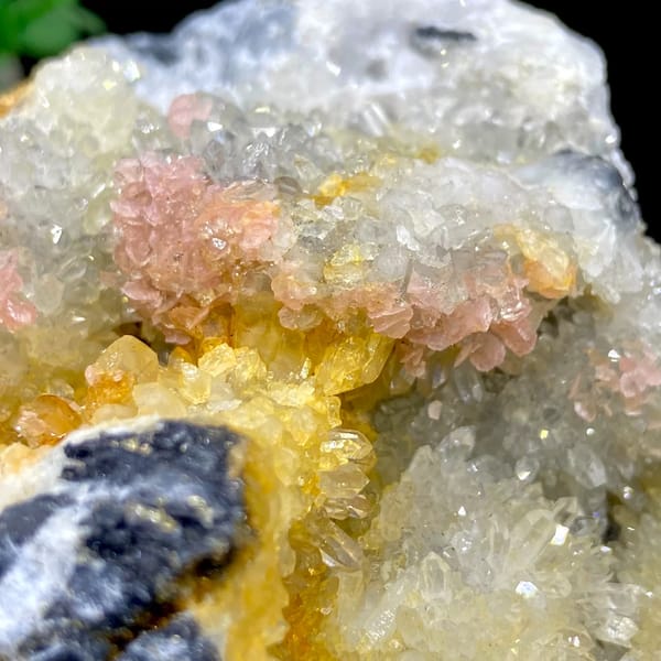 Platy rhodochrosite in quartz pocket rimmed by dark sulfide from Guangxi, China, side view