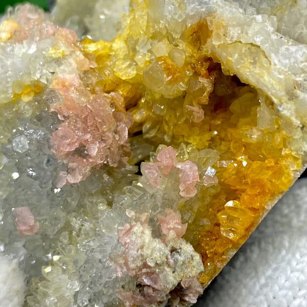Platy rhodochrosite in quartz pocket rimmed by dark sulfide from Guangxi, China, close-up of terminations