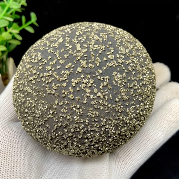 Iron concretion sphere dusted with pyrite from Yunnan, China, close-up of the crystal faces
