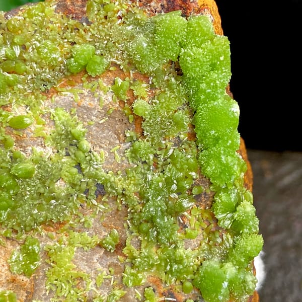 Lime-green botryoidal pyromorphite over rusty plate from Gongcheng, Guangxi, China, close-up of the crystal faces