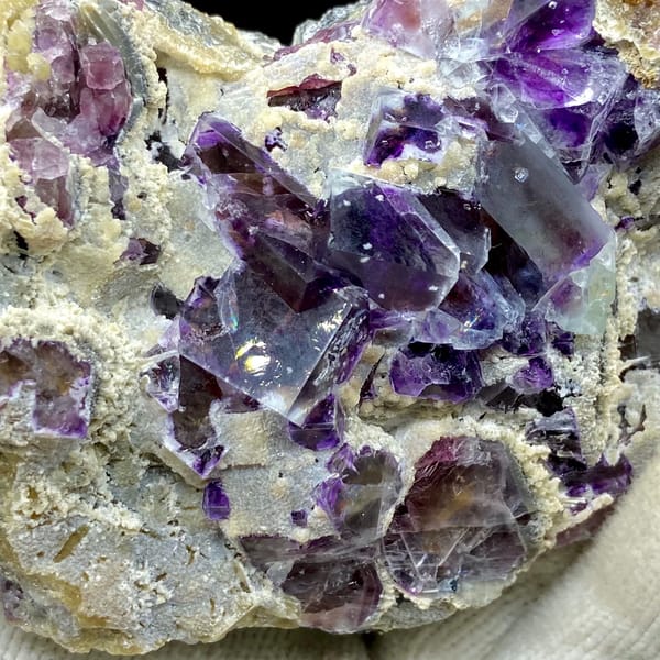Transparent purple phantom fluorite cubes on tan matrix from Inner Mongolia, China, second angle