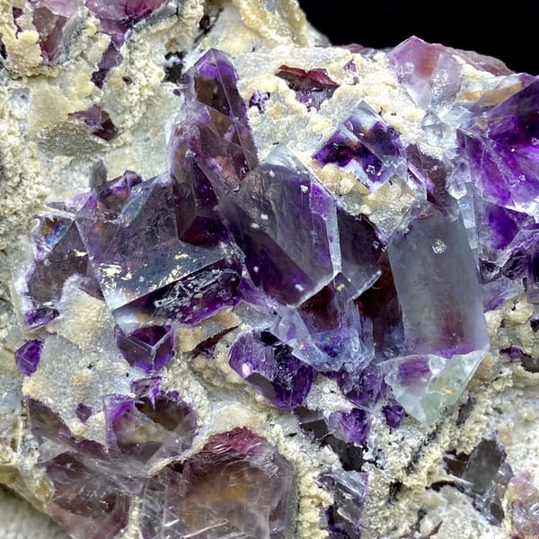 Transparent purple phantom fluorite cubes on tan matrix from Inner Mongolia, China, reverse side