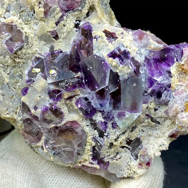 Transparent purple phantom fluorite cubes on tan matrix from Inner Mongolia, China, overall view