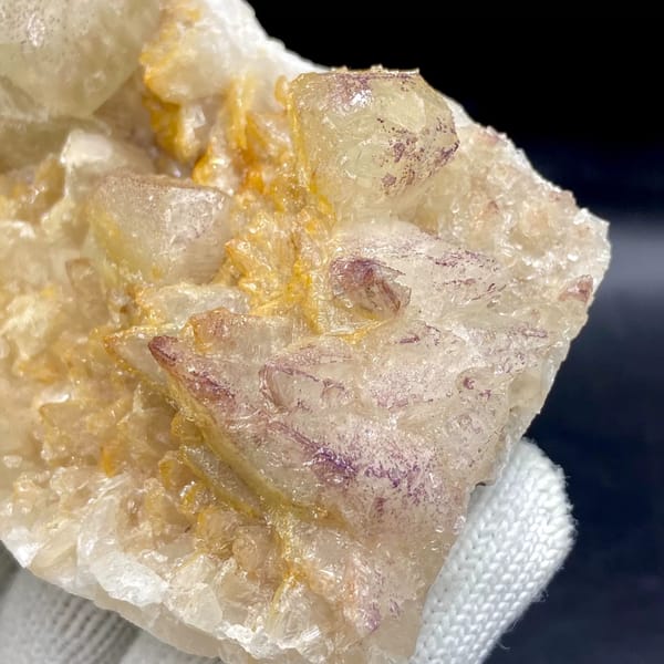 Pale calcite rhombs with yttrian fluorite on golden quartz from Guizhou, China, reverse side