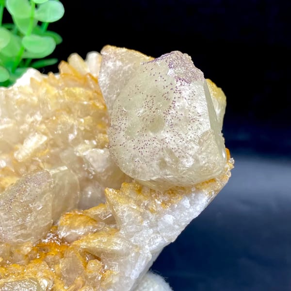 Pale calcite rhombs with yttrian fluorite on golden quartz from Guizhou, China, side view