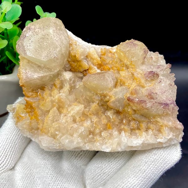 Pale calcite rhombs with yttrian fluorite on golden quartz from Guizhou, China, overall view