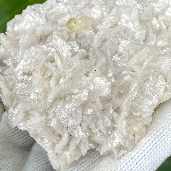 White dolomite plate with small pale calcite crystal from Guizhou, China, top view