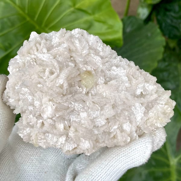 White dolomite plate with small pale calcite crystal from Guizhou, China, close-up of terminations