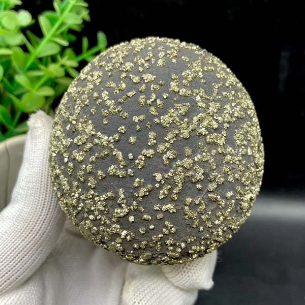 Dark iron concretion ball speckled with pyrite grains from Yunnan, China, top view