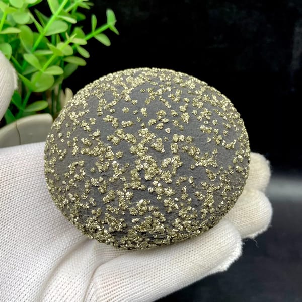 Dark iron concretion ball speckled with pyrite grains from Yunnan, China, detail of the matrix contact