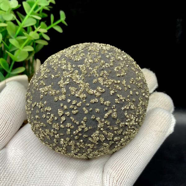 Dark iron concretion ball speckled with pyrite grains from Yunnan, China, side view