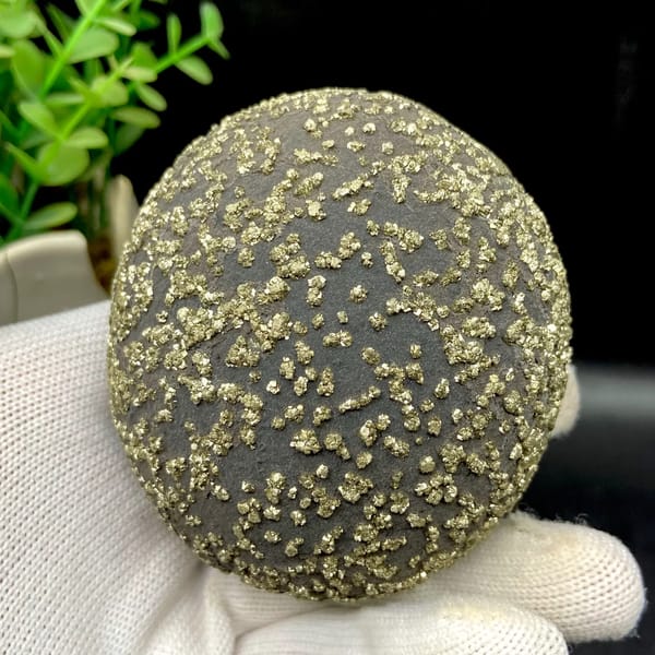 Dark iron concretion ball speckled with pyrite grains from Yunnan, China, close-up of terminations