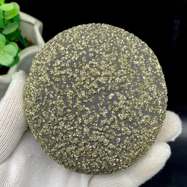 Iron concretion sphere speckled with pyrite from Yunnan, China, close-up of the crystal faces