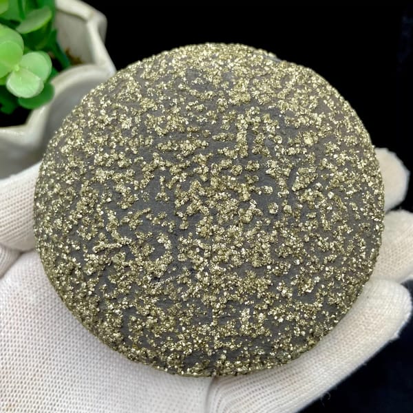 Iron concretion sphere speckled with pyrite from Yunnan, China, detail of the matrix contact