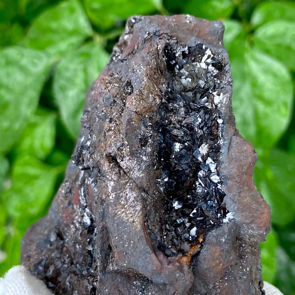 Mass of platy black hematite from Yunnan, China, detail of the matrix contact